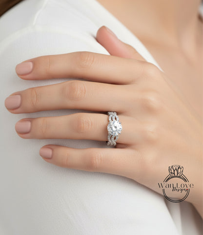 A close-up of a person's hand wearing a diamond engagement ring on the ring finger.
