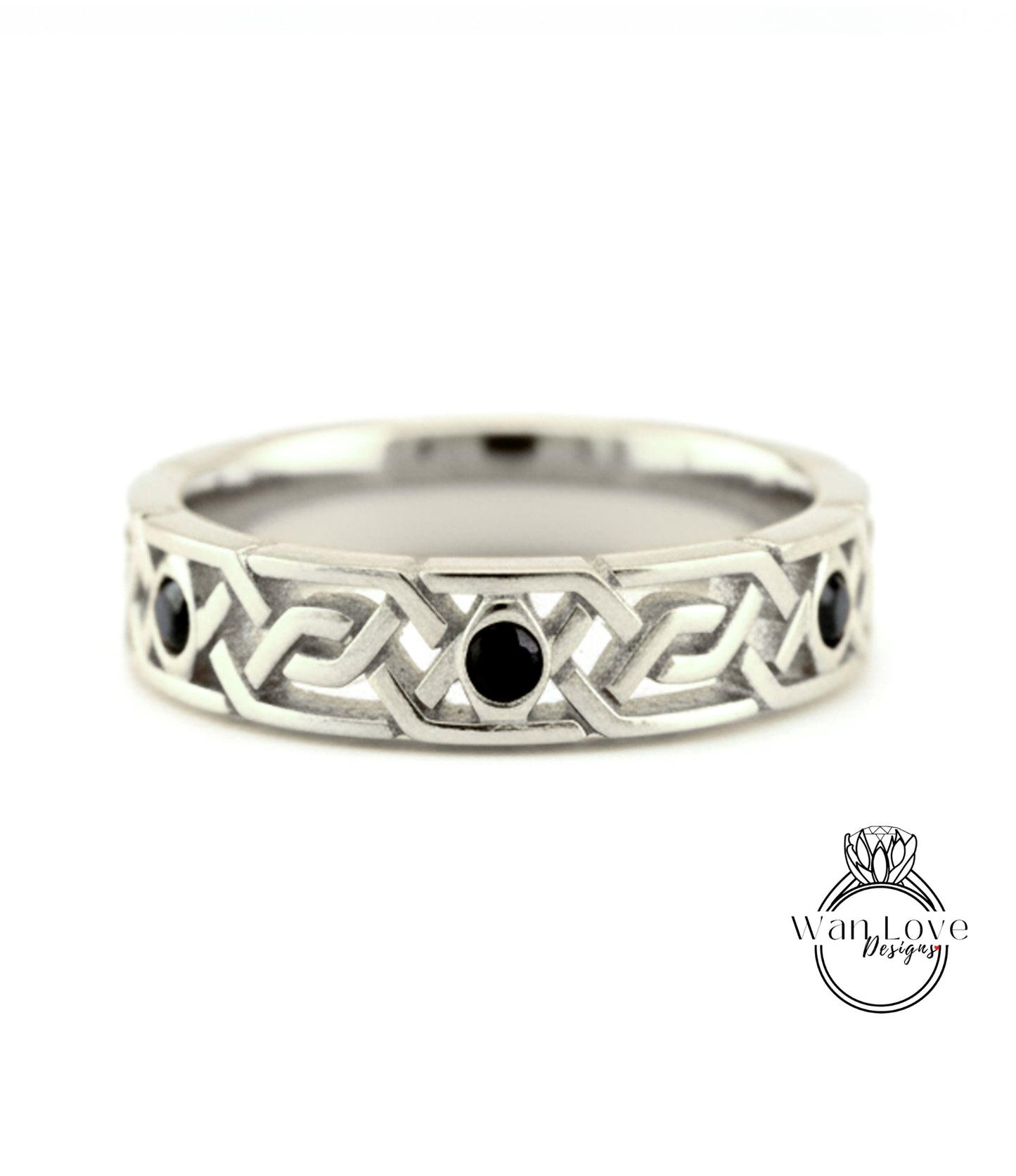 A silver band ring with a geometric design and three black gemstones.