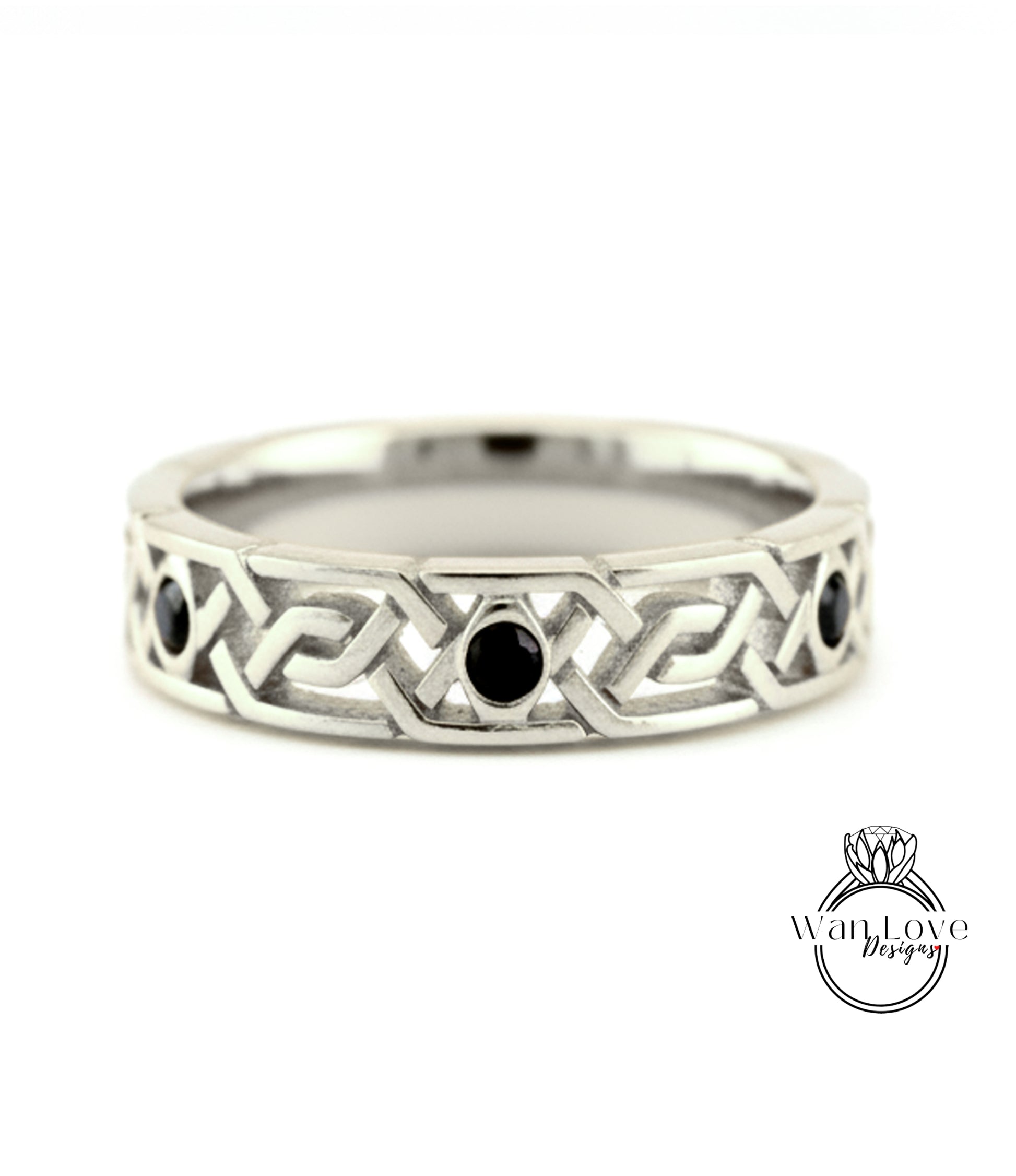 A silver band ring with a geometric design and three black gemstones.