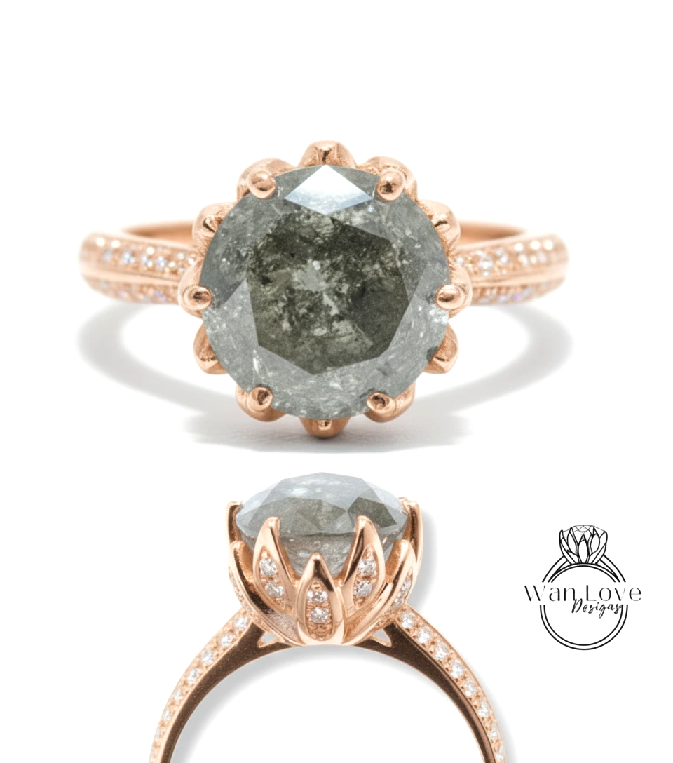 a large, grey diamond ring with a rose gold band and small diamonds set in the center.