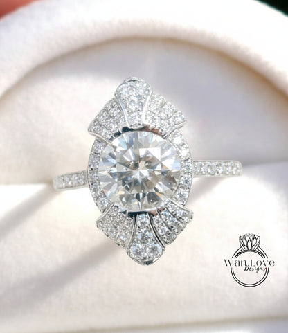 A close-up image of a diamond engagement ring with a large central diamond surrounded by smaller diamonds on the band.