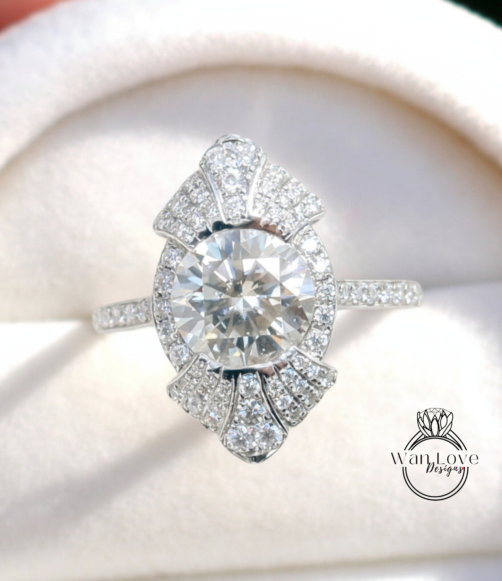 A close-up image of a diamond engagement ring with a large central diamond surrounded by smaller diamonds on the band.