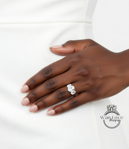 A close-up of a hand wearing a diamond ring on the ring finger.