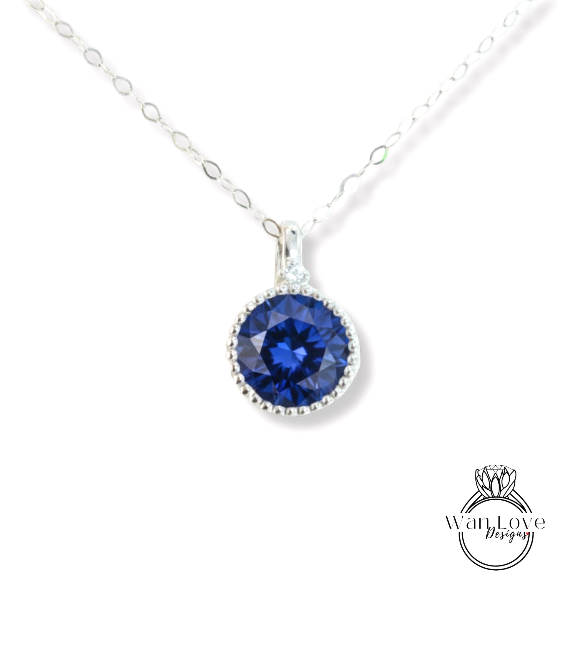 A necklace with a large blue gemstone pendant, which appears to be a sapphire.