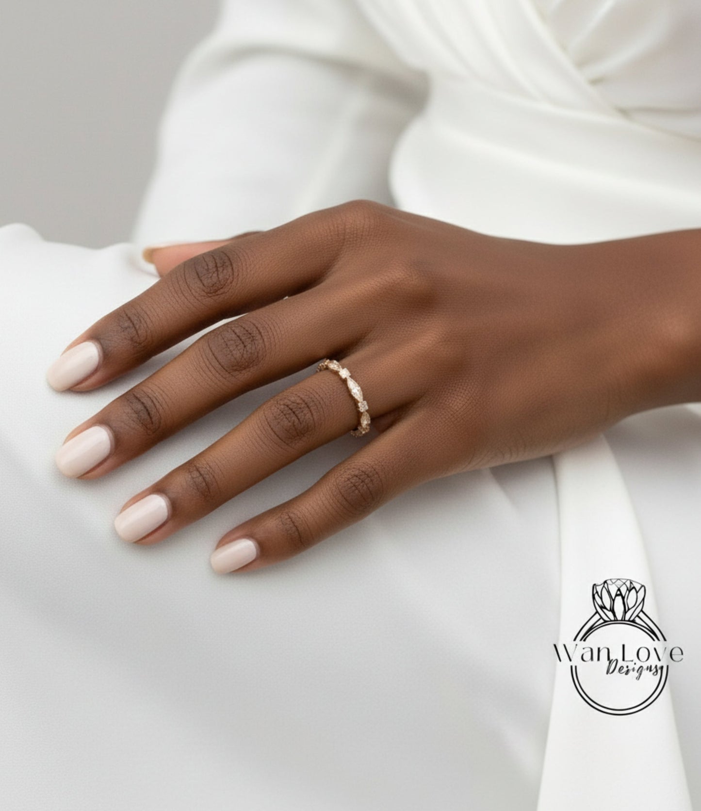 A close-up of a hand wearing a gold ring on the ring finger.