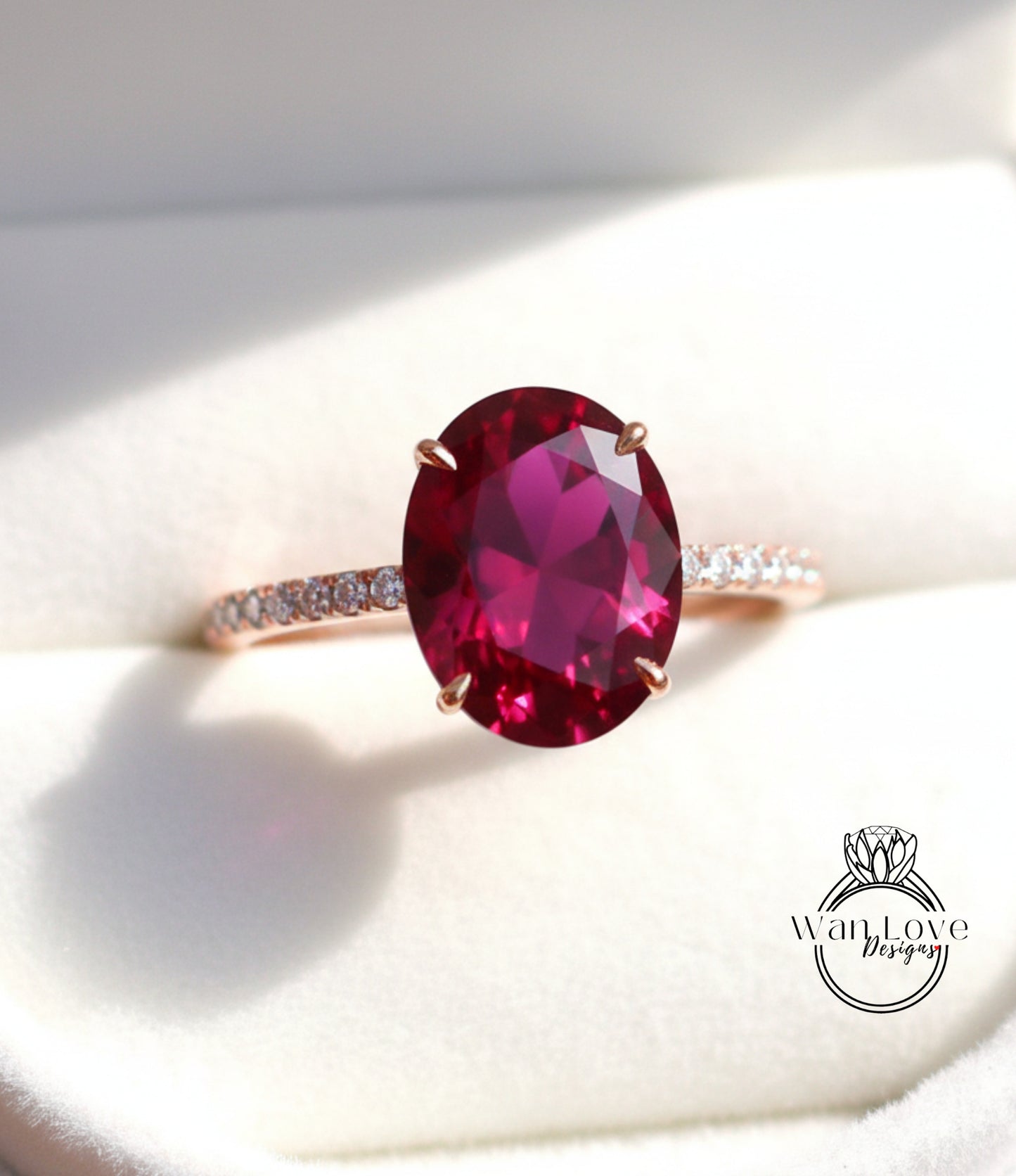 A close-up image of a pink gemstone ring with a large oval-shaped gemstone set in a gold band.