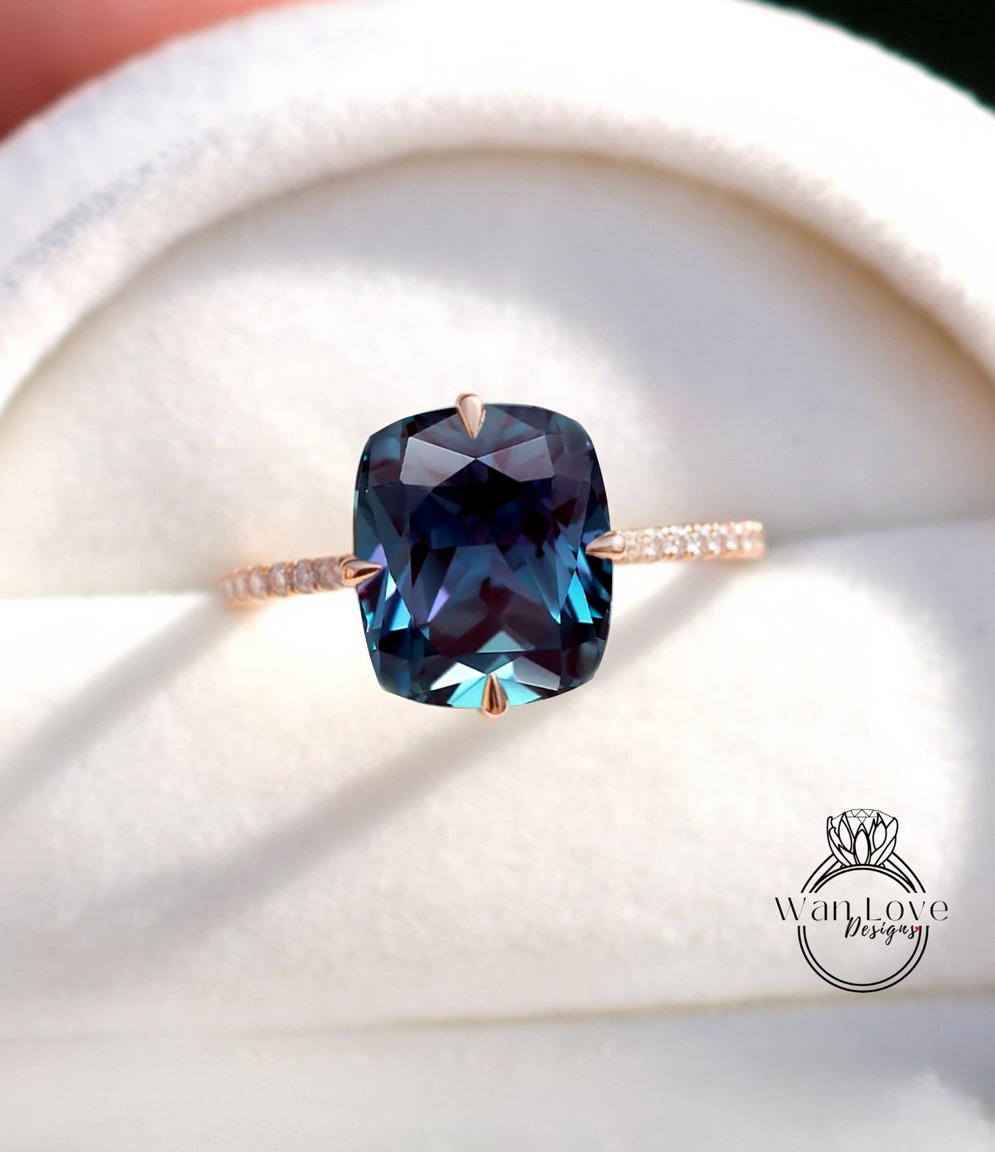 A close-up image of a ring with a large blue gemstone, likely a sapphire, set in a gold band.