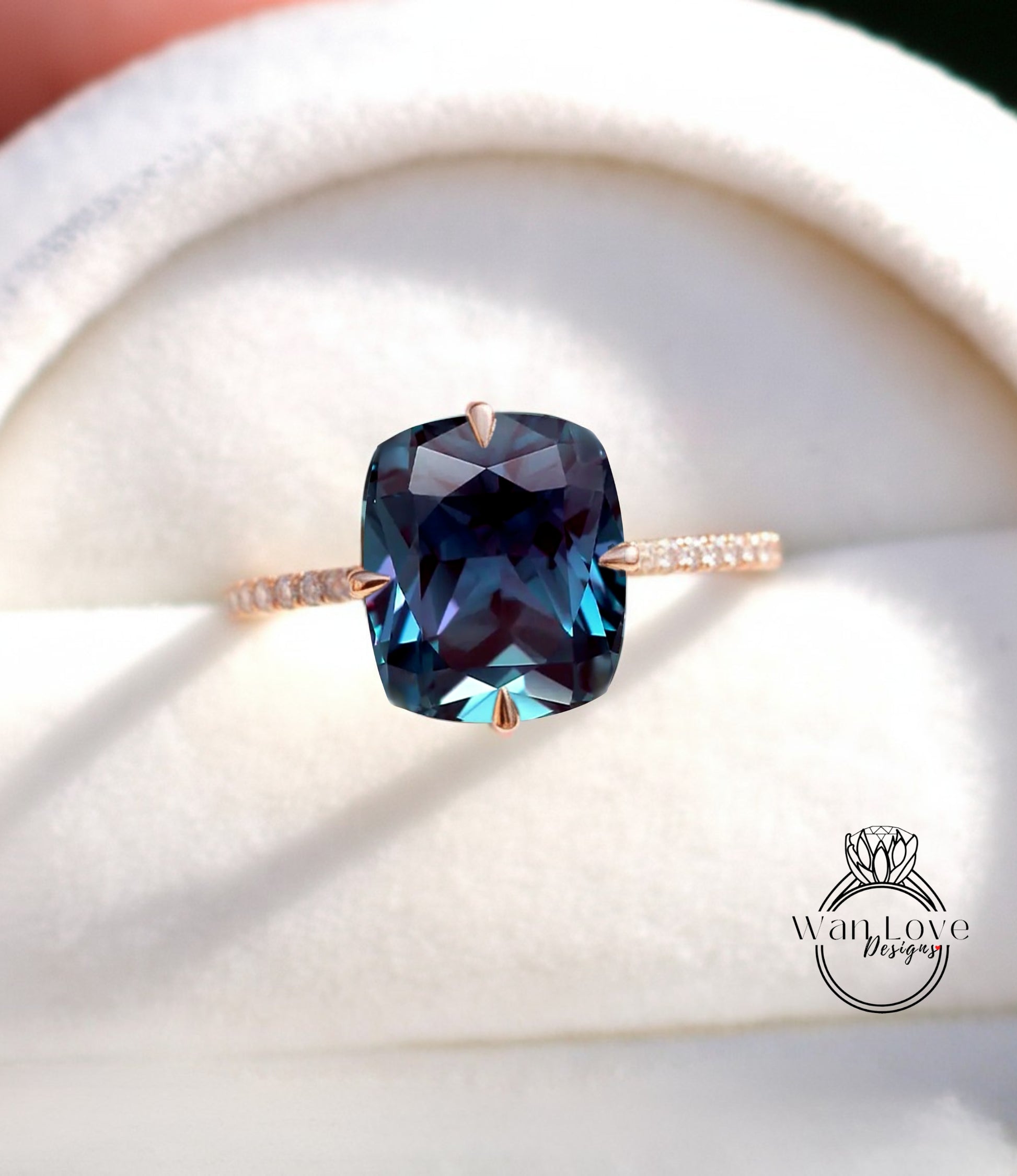 A close-up image of a ring with a large blue gemstone, likely a sapphire, set in a gold band.