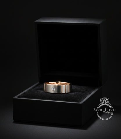 A gold ring with a diamond set in the center is displayed in a black jewelry box against a dark background.