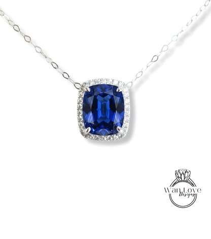 A necklace with a large blue gemstone, likely a sapphire, set in a halo of smaller diamonds.