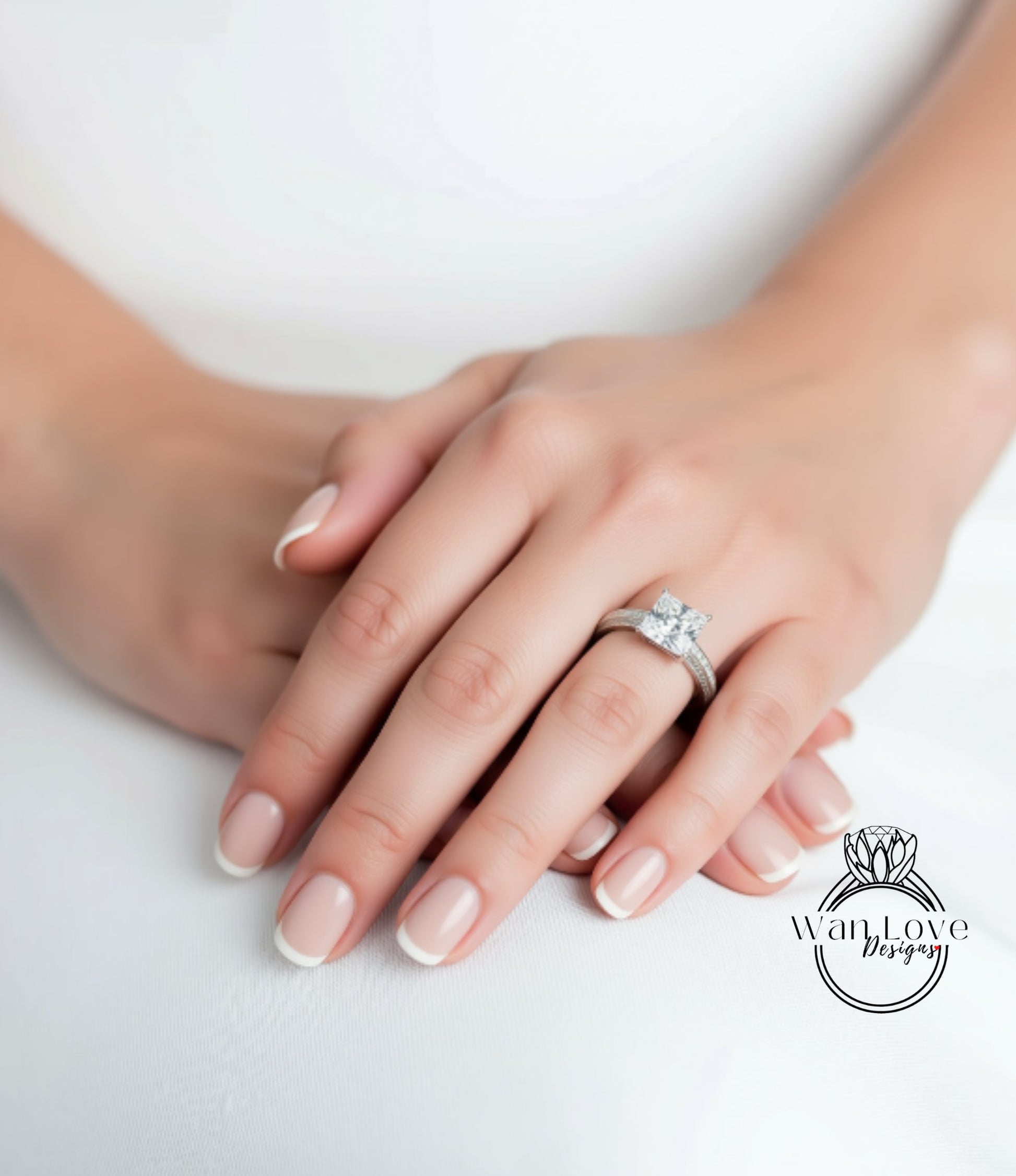 A close-up of a person's hands with a diamond engagement ring on the ring finger.