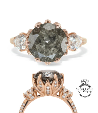 a beautiful engagement ring with a large, dark grey diamond as the centerpiece. The ring is adorned with smaller diamonds and has a rose gold band. The image also includes a close-up view of the ring's band and a side view of the diamond.
