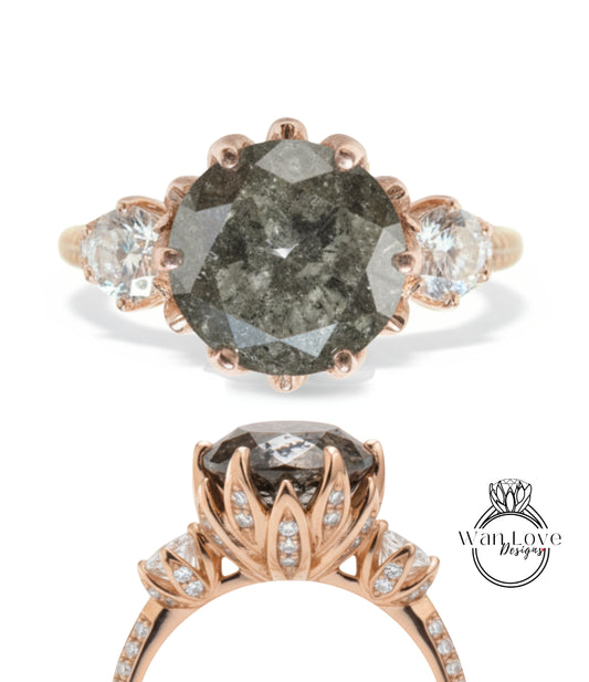 a beautiful engagement ring with a large, dark grey diamond as the centerpiece. The ring is adorned with smaller diamonds and has a rose gold band. The image also includes a close-up view of the ring's band and a side view of the diamond.