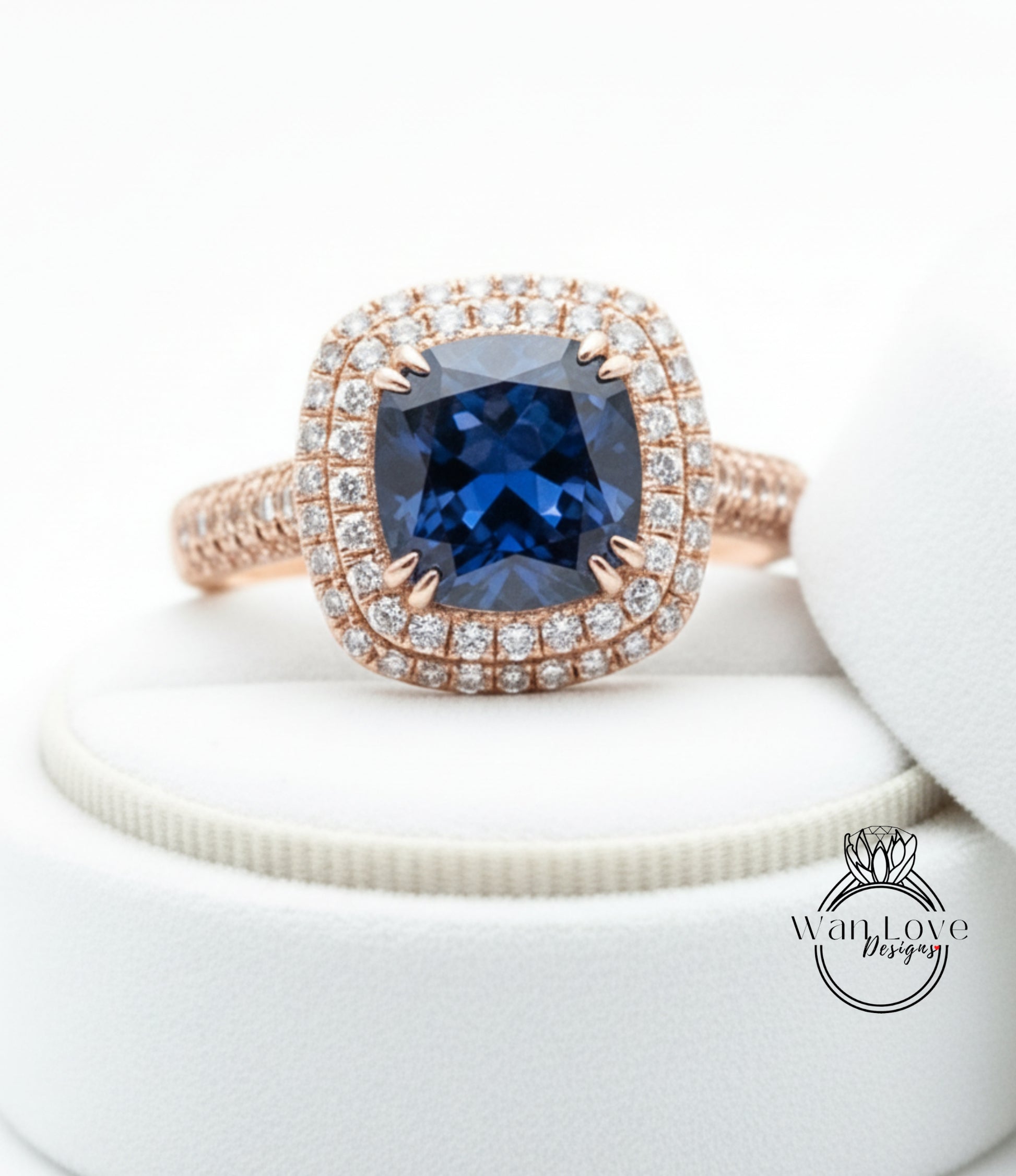 A close-up image of a diamond engagement ring with a large blue gemstone set in a halo of smaller diamonds.