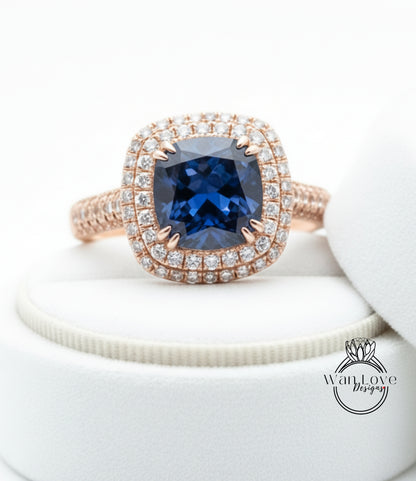 A close-up image of a diamond engagement ring with a large blue gemstone set in a halo of smaller diamonds.