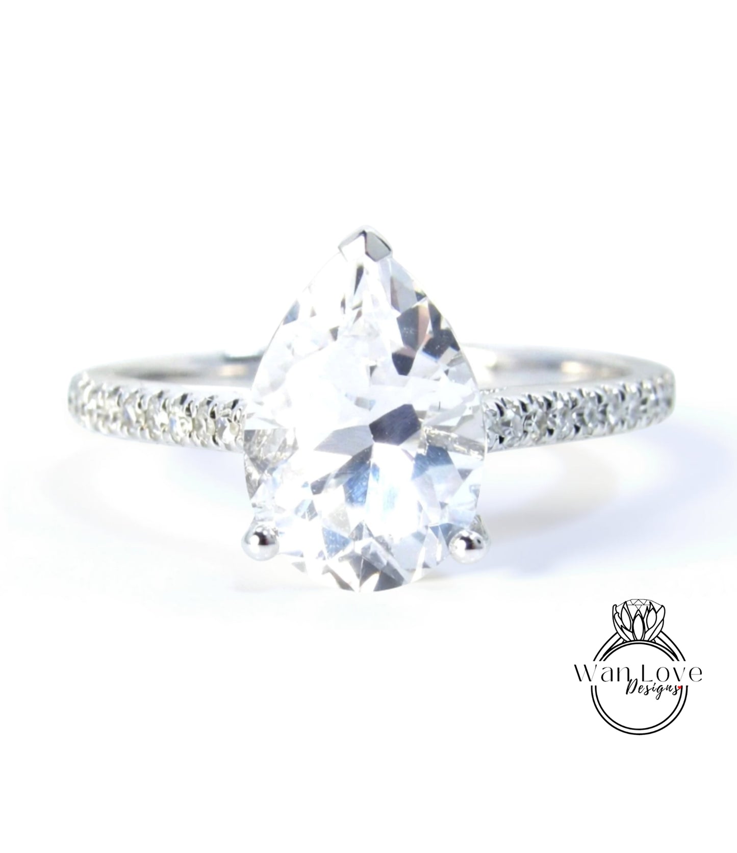A close-up of a diamond engagement ring with a large, clear gemstone set in a silver band.