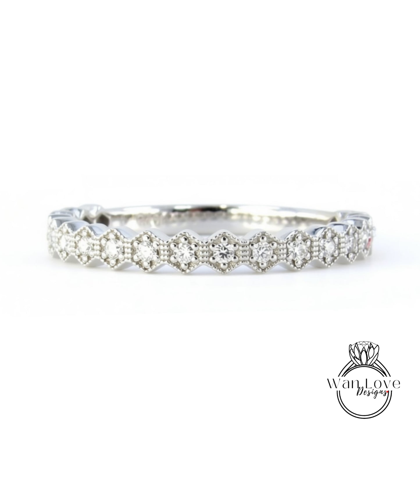 A silver band adorned with numerous small diamonds arranged in a repeating pattern.