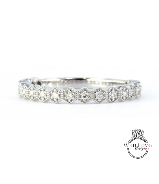 A silver band adorned with numerous small diamonds arranged in a repeating pattern.