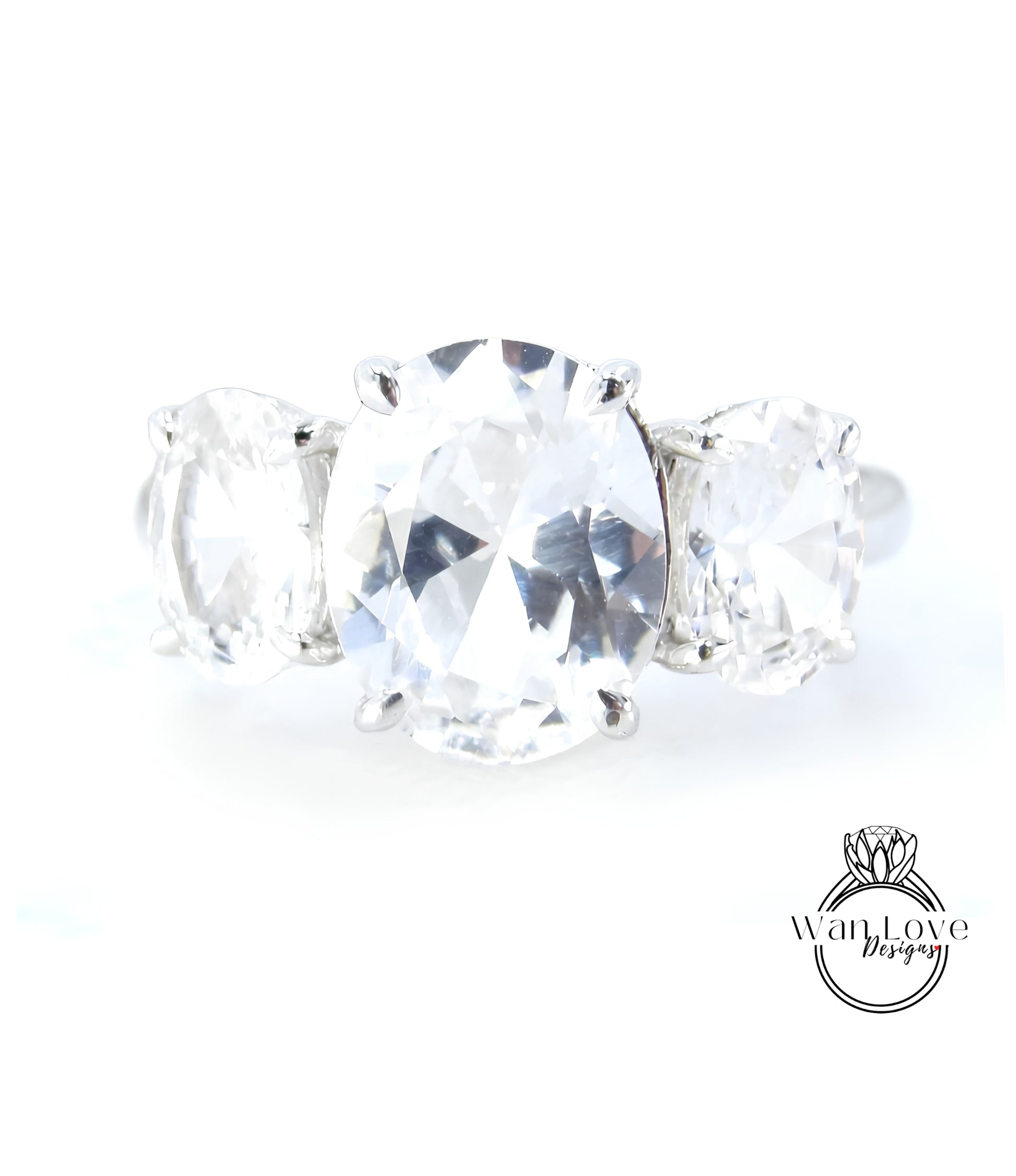 A close-up image of a diamond ring with a large oval-shaped diamond in the center, surrounded by smaller diamonds.