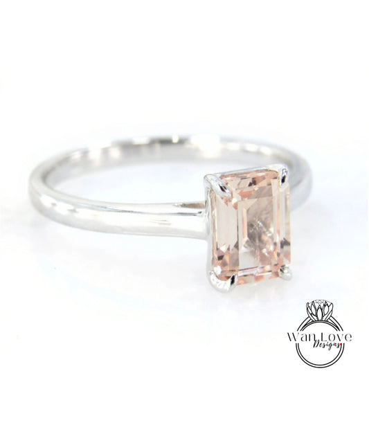 A silver ring with a large, rectangular-shaped gemstone set in the center.