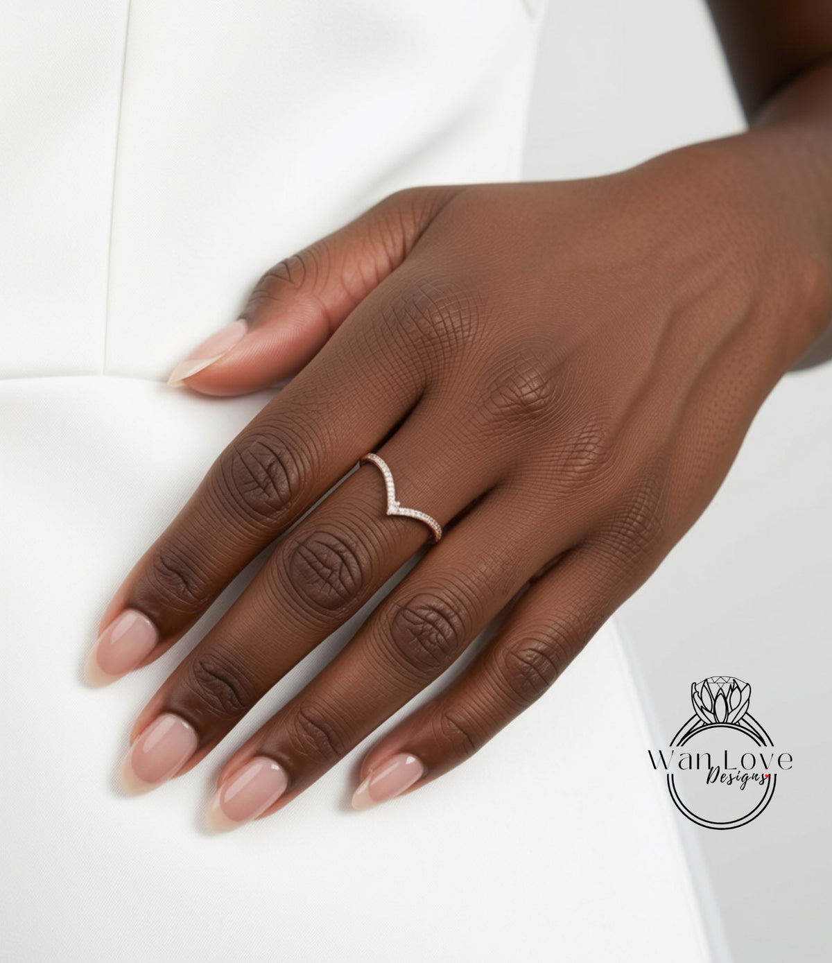 A close-up of a person's hand wearing a ring on the ring finger.