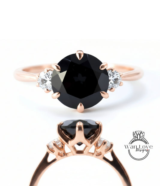 a rose gold ring with a large black diamond as the centerpiece, surrounded by smaller diamonds.