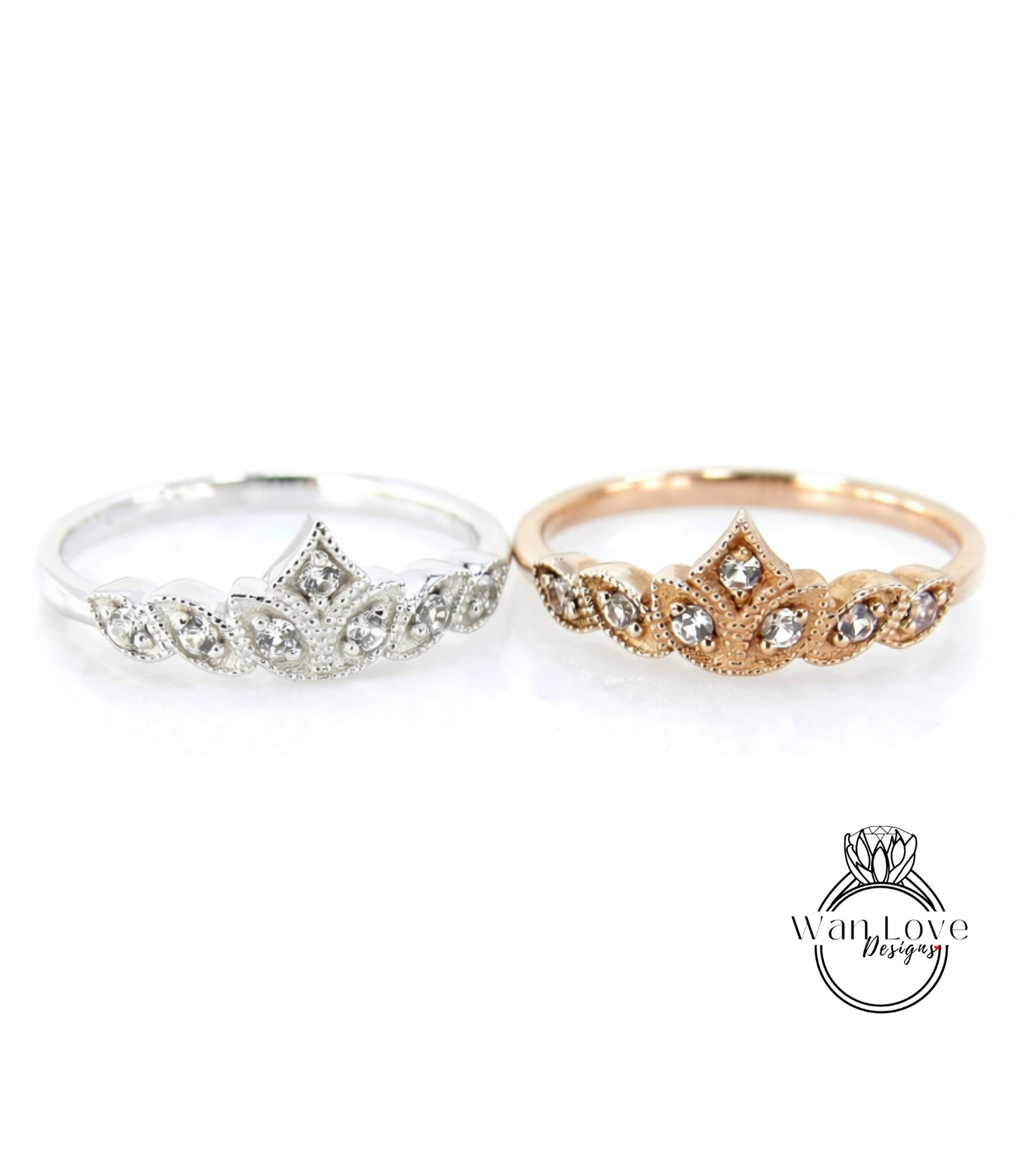 Two rings with a crown-like design, one silver and one gold, are displayed against a white background.
