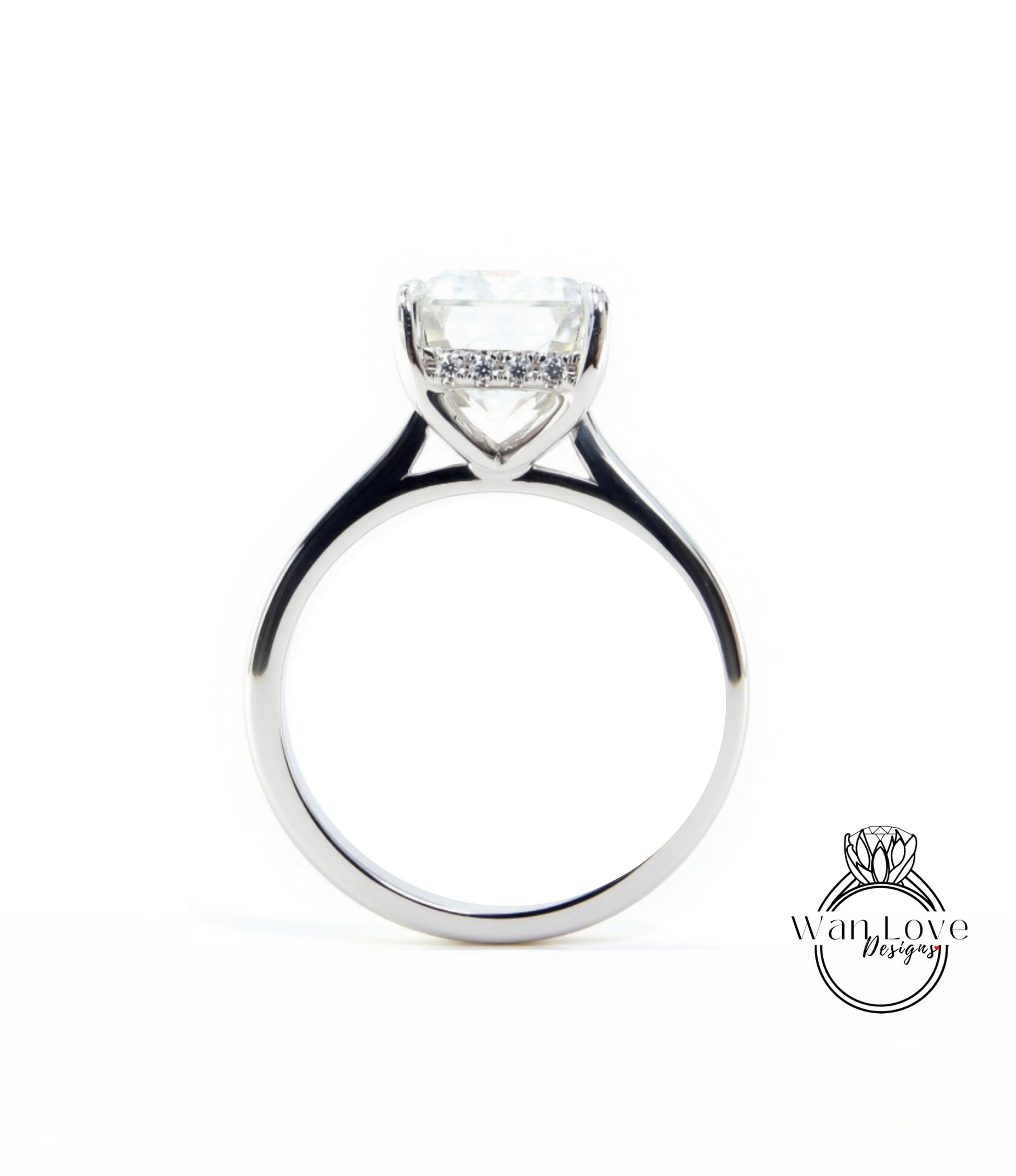 A silver engagement ring with a large, clear gemstone set in the center of the band.