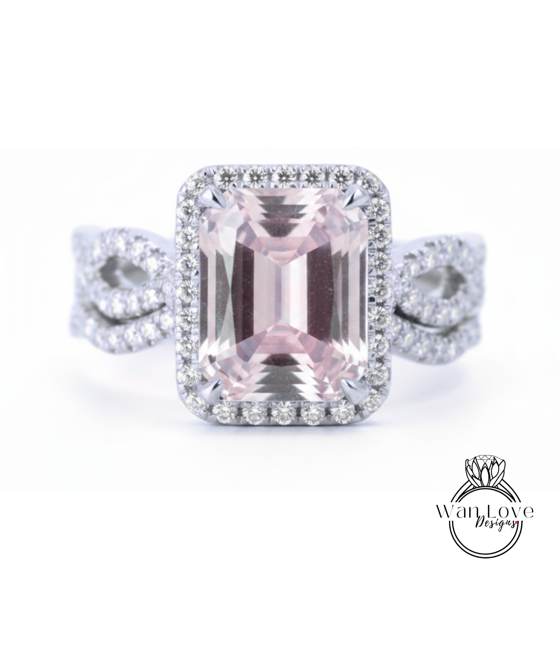 A large, pink gemstone ring with a halo of smaller diamonds around it, set in a silver band.