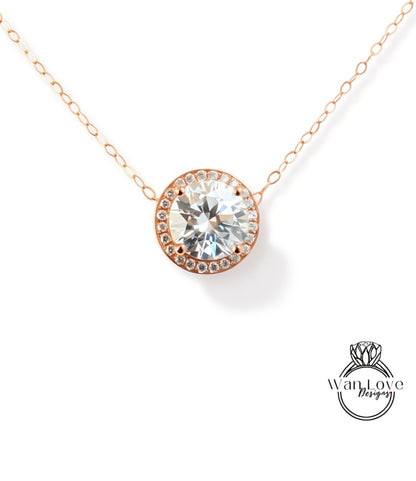 A necklace with a large, clear gemstone pendant, possibly a diamond, set in a halo of smaller diamonds.