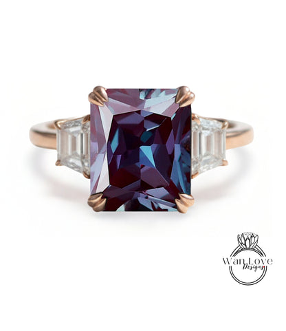 A large, purple gemstone ring with a gold band and three smaller diamonds on either side.