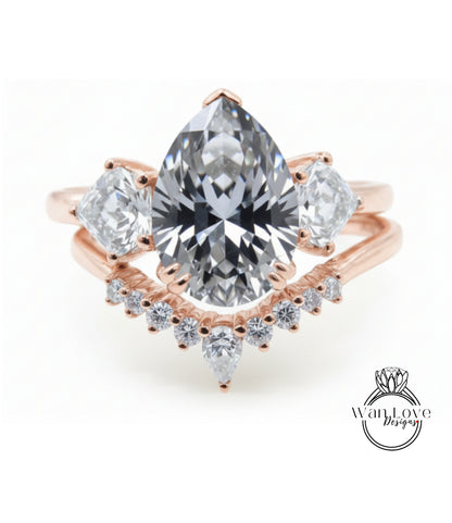 a beautiful engagement ring with a large pear-shaped diamond set in a rose gold band, surrounded by smaller diamonds.