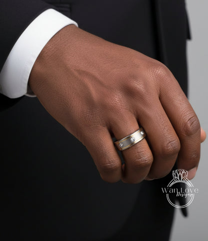 A close-up of a person's hand wearing a silver ring with a diamond.