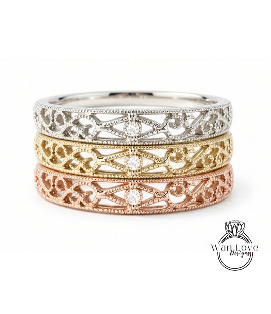 A three-band ring with intricate designs in silver, gold, and rose gold.