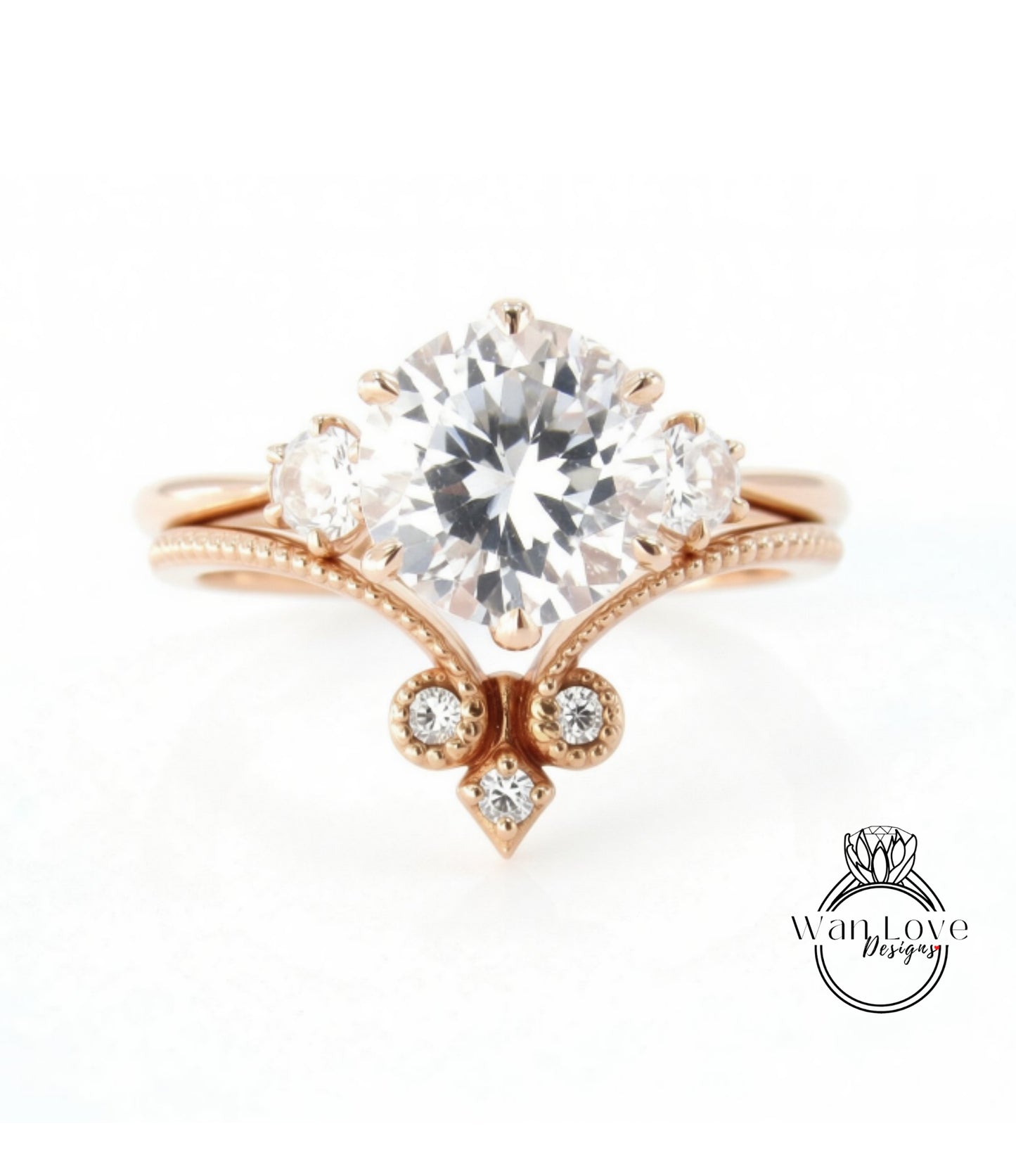 a beautiful engagement ring with a large central diamond surrounded by smaller diamonds on either side.