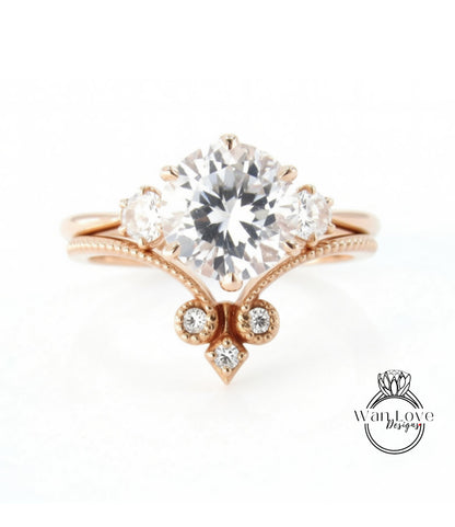 a beautiful engagement ring with a large central diamond surrounded by smaller diamonds on either side.