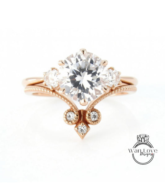 a beautiful engagement ring with a large central diamond surrounded by smaller diamonds on either side.