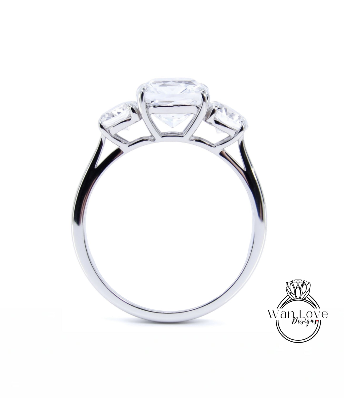 A silver engagement ring with a large central diamond and three smaller diamonds on either side.