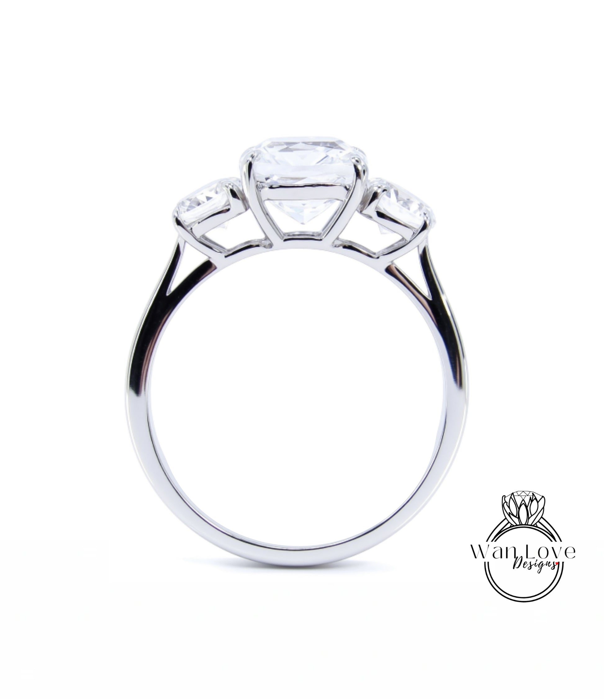 A silver engagement ring with a large central diamond and three smaller diamonds on either side.