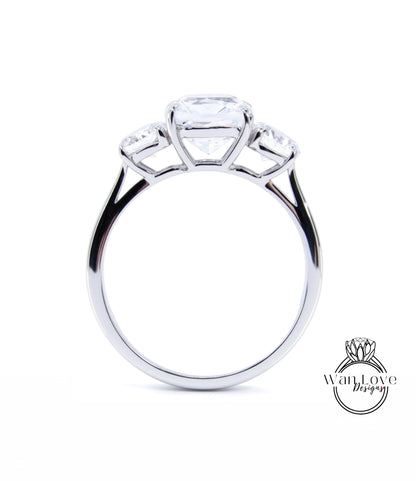 A silver engagement ring with a large central diamond and three smaller diamonds on either side.