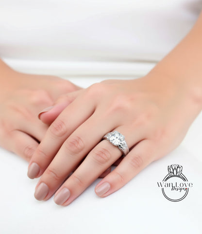 A close-up of a person's hand wearing a large diamond engagement ring.