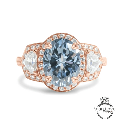 A beautiful engagement ring with a large blue gemstone surrounded by smaller diamonds and a halo of smaller diamonds.