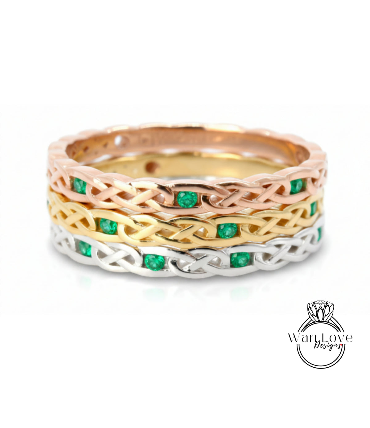 A ring with a Celtic knot design and green gemstones.
