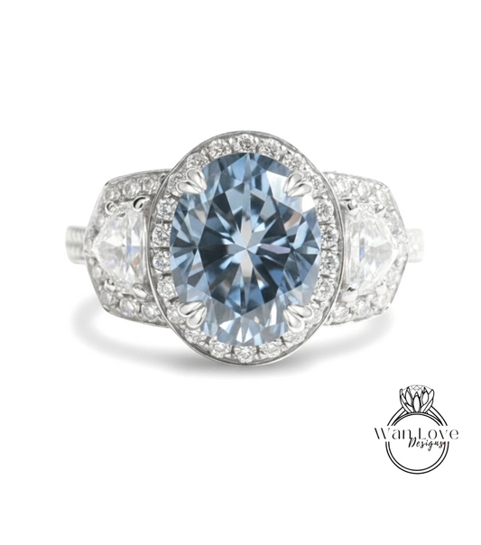 A stunning blue diamond ring with a large central diamond surrounded by smaller diamonds, set in a halo of smaller diamonds.