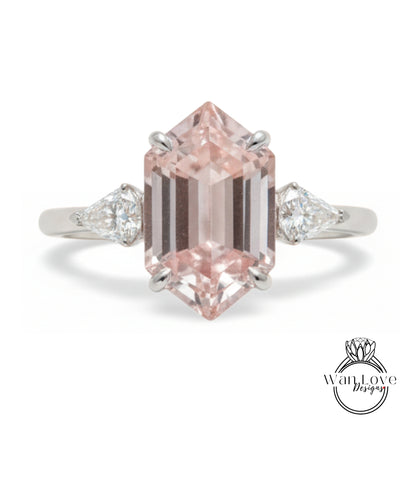 A beautiful engagement ring featuring a large, pink gemstone set in a silver band.