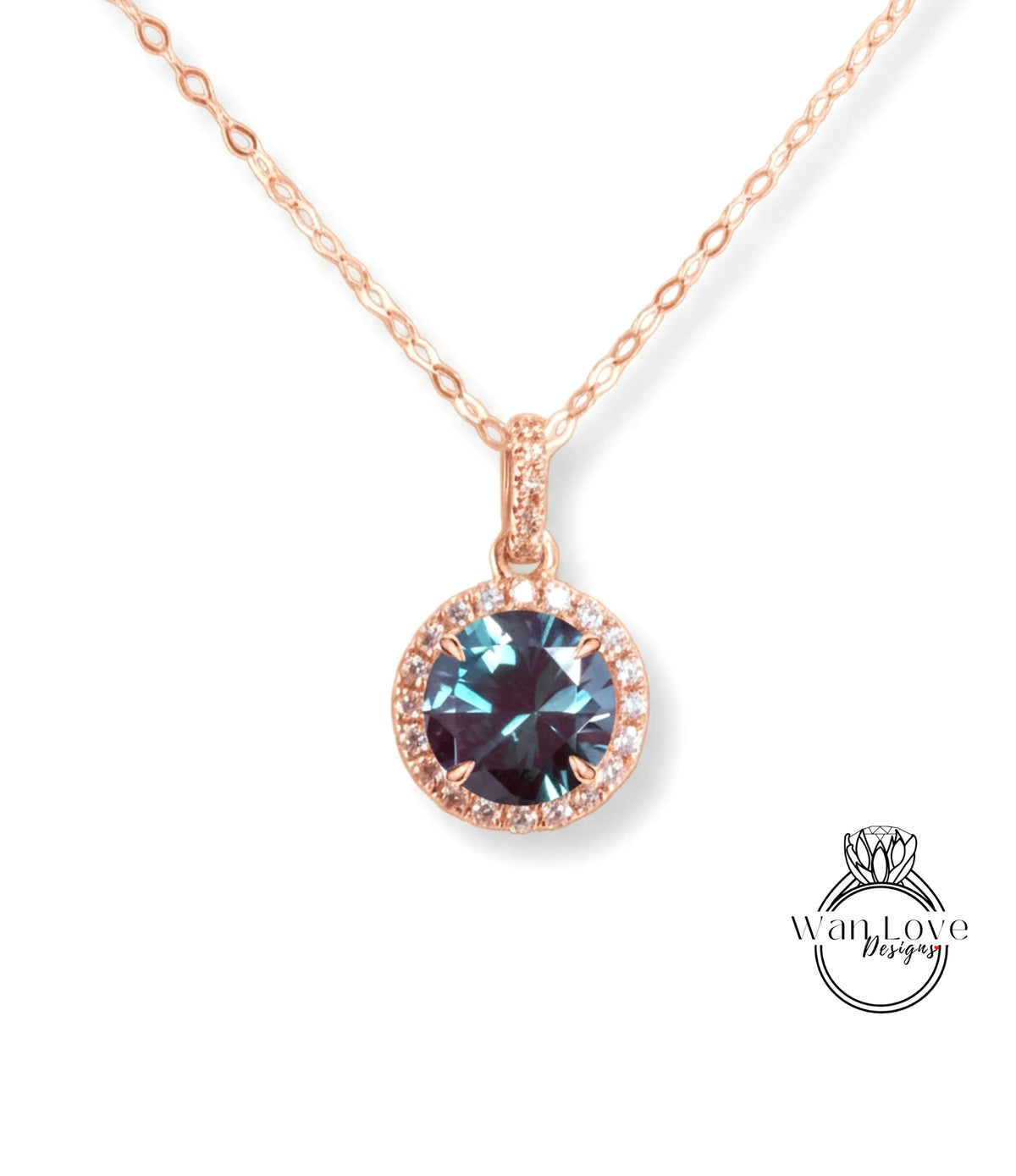 A rose gold necklace with a large blue gemstone pendant.