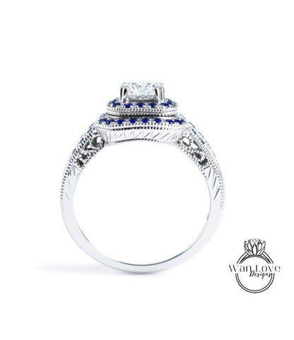 A silver ring with a large diamond at the center, surrounded by blue gemstones.