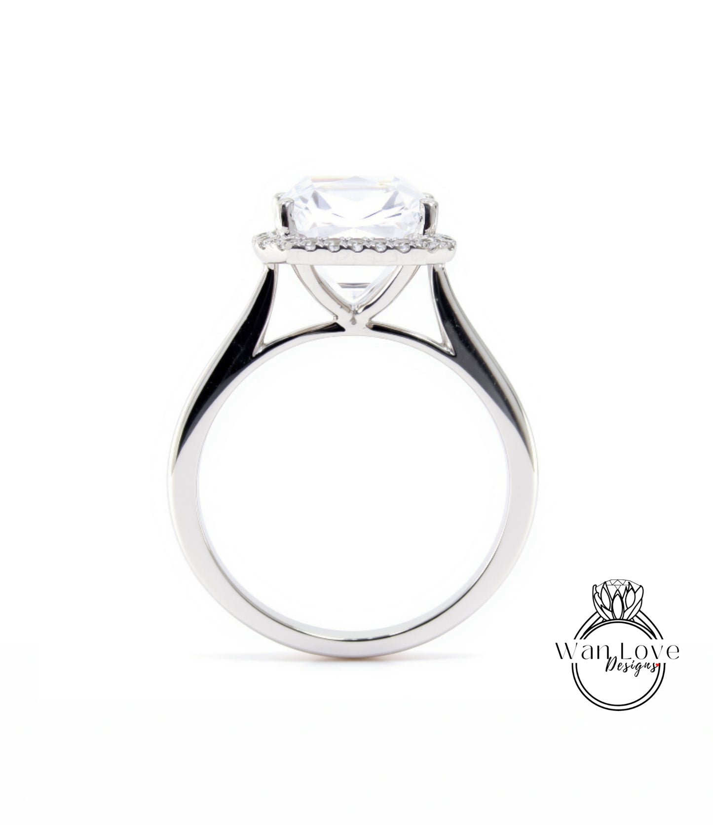 A silver engagement ring with a large, clear gemstone set in the center, surrounded by a halo of smaller diamonds.