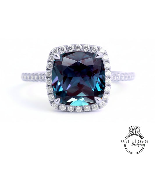A stunning blue gemstone ring with a halo of diamonds around the center stone.