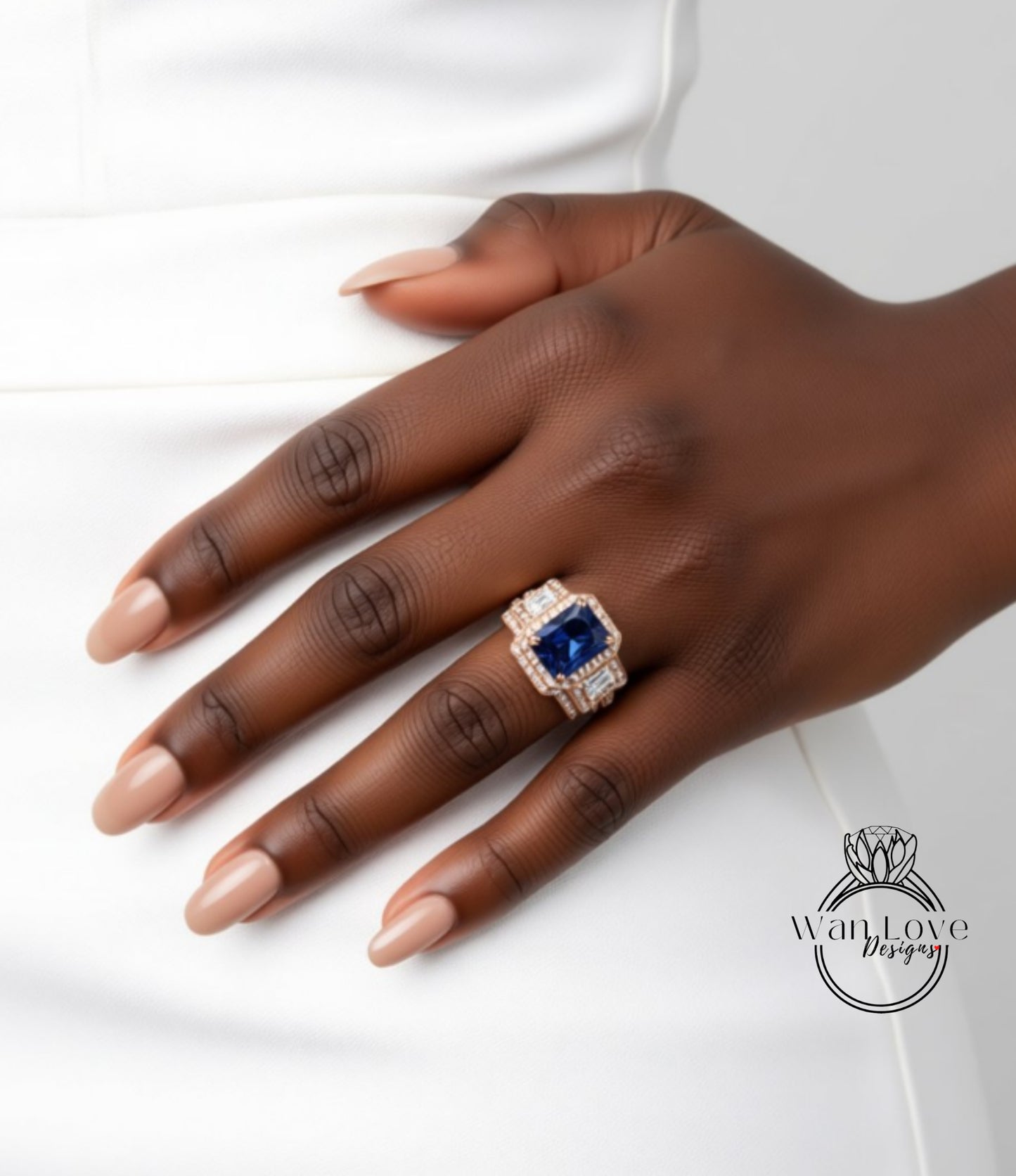 A close-up of a hand wearing a ring with a large blue gemstone.